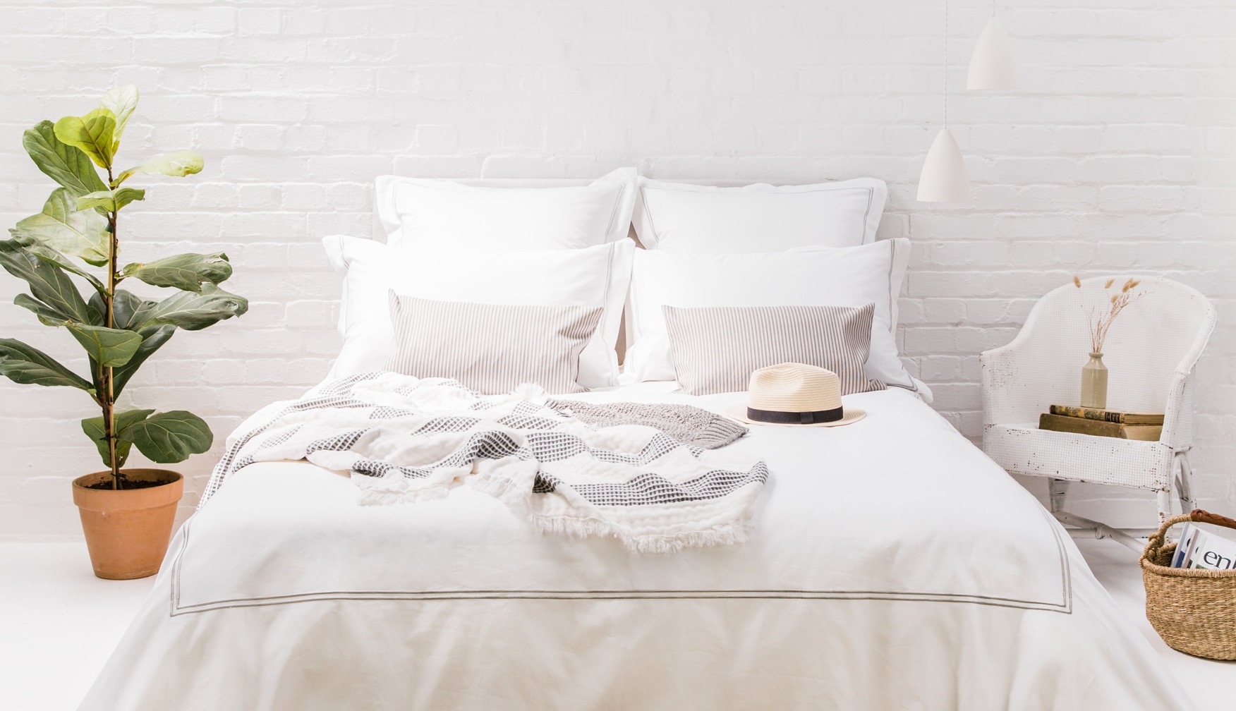 Hotelbett mit weißer Bettwäsche und Kissen